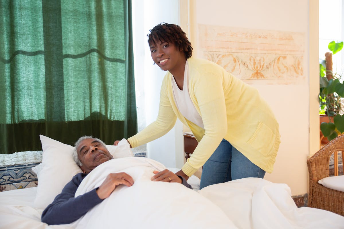 Carer helping an elderly woman at home