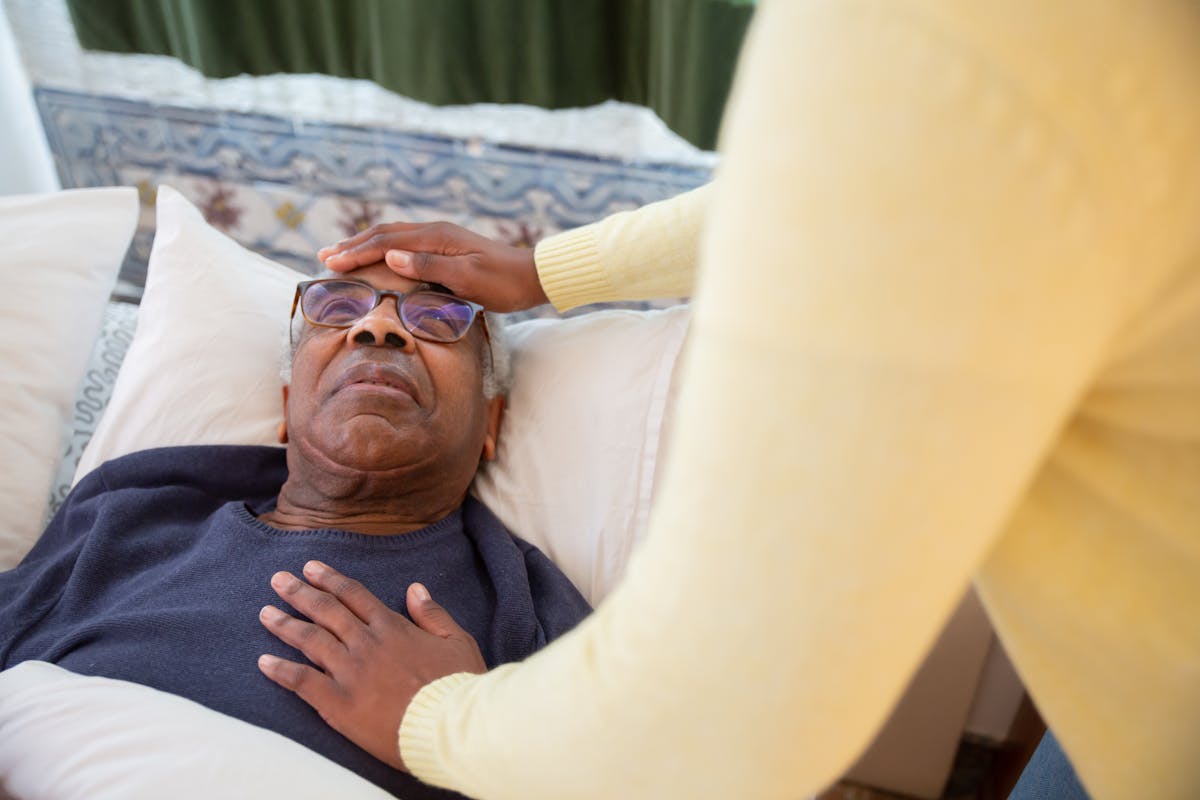 Live-in carer supporting an elderly man